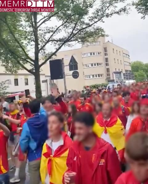 A group of people in red and yellow shirtsDescription automatically generated