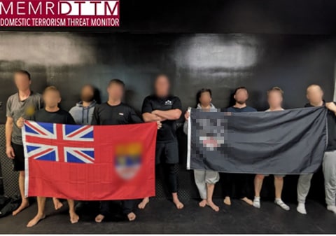 A group of people holding flagsDescription automatically generated