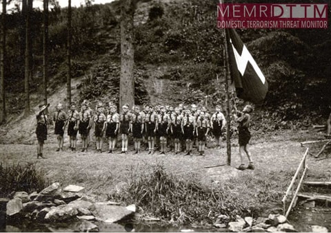 A group of people standing in a line holding a flagDescription automatically generated with low confidence