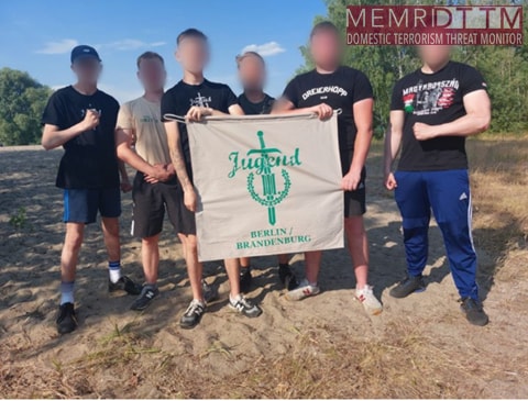 A group of people holding a bannerDescription automatically generated